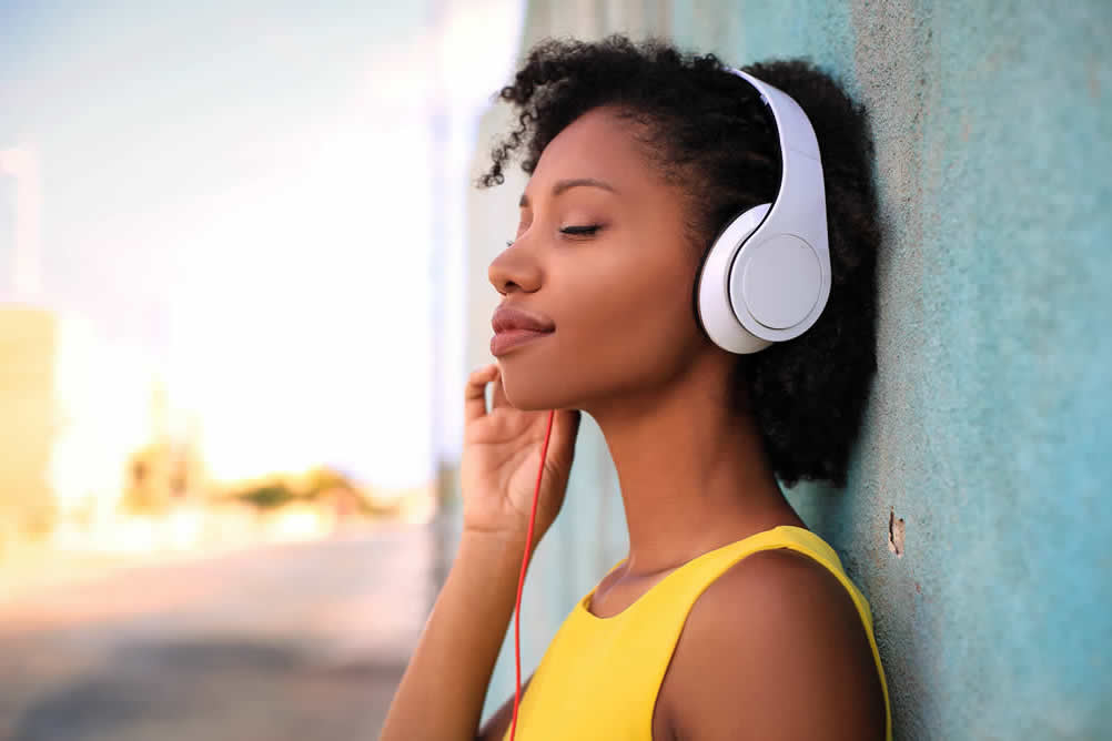woman listening to music using headphones