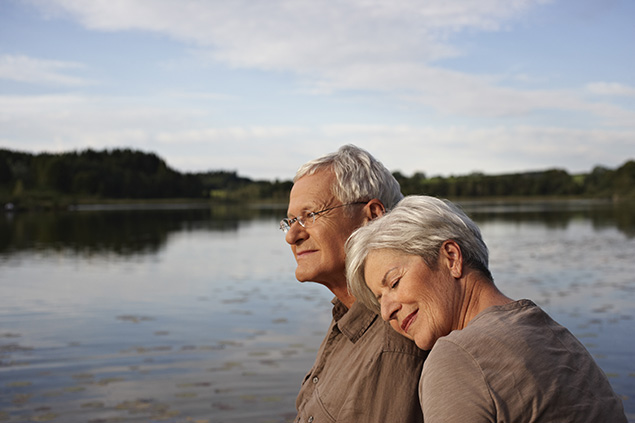 Elderly couple embracing outside