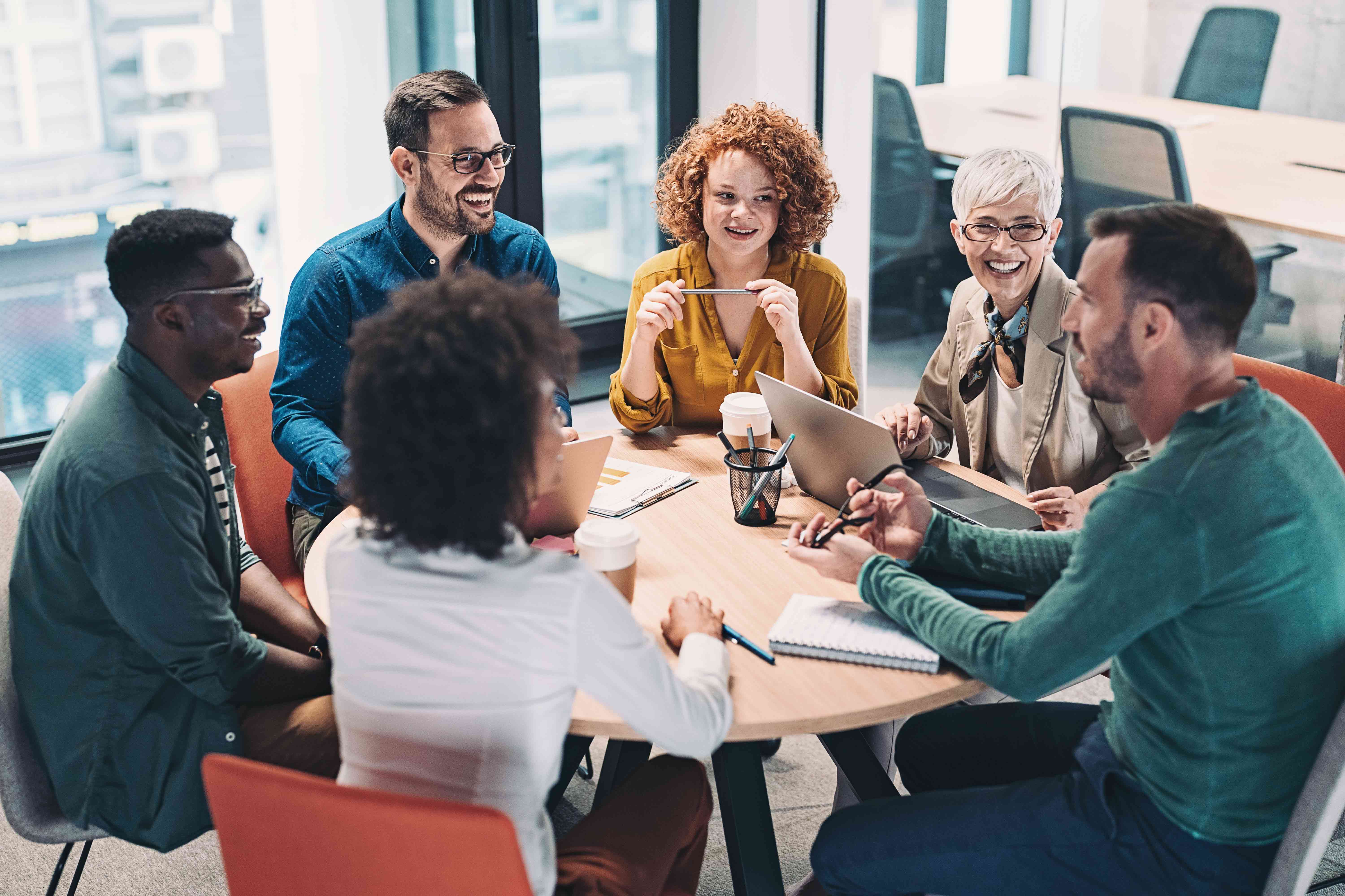 Smiling diverse team chatting around a table