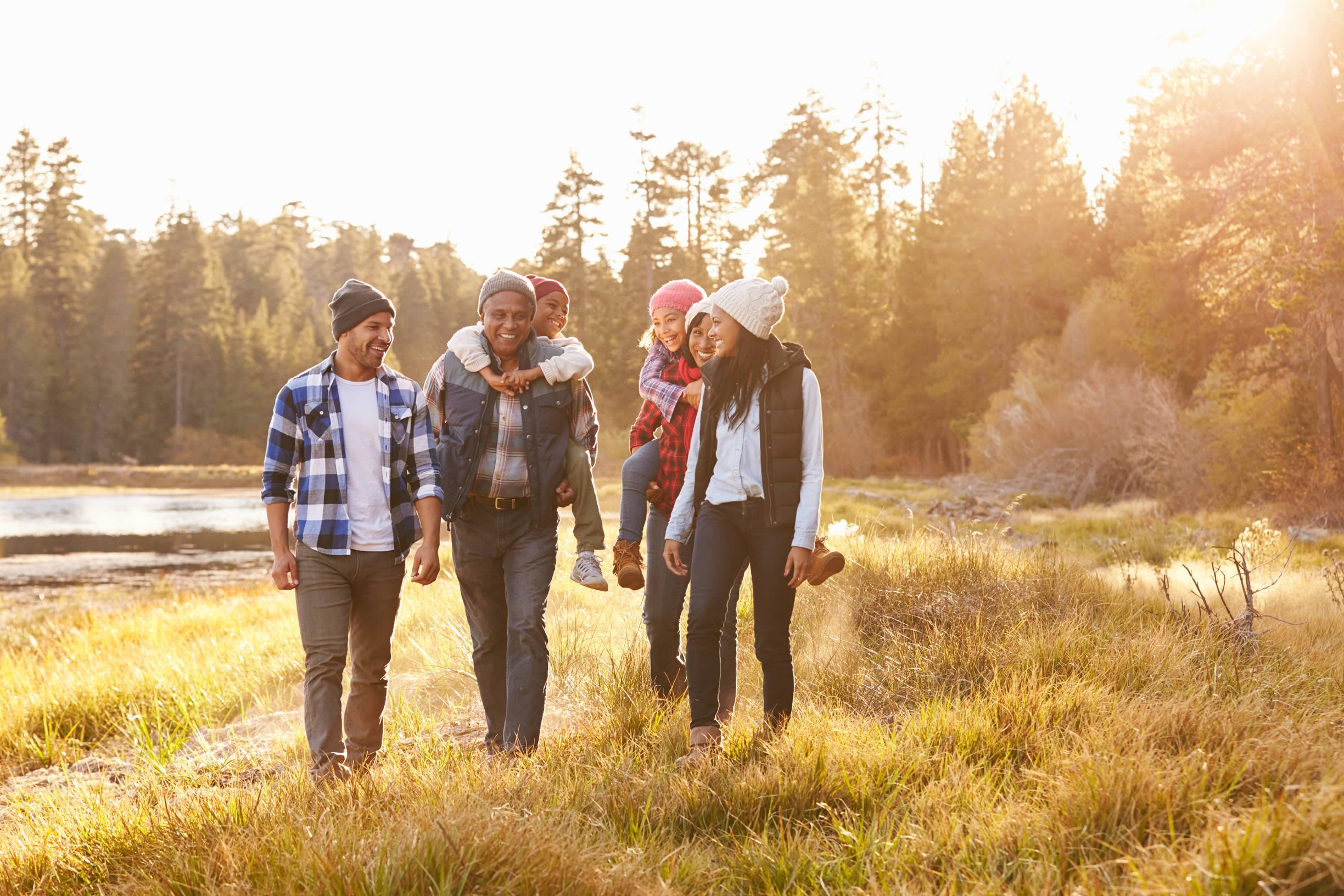 Family walking in forest smiling