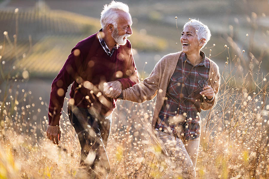 Smiling man and woman in a field