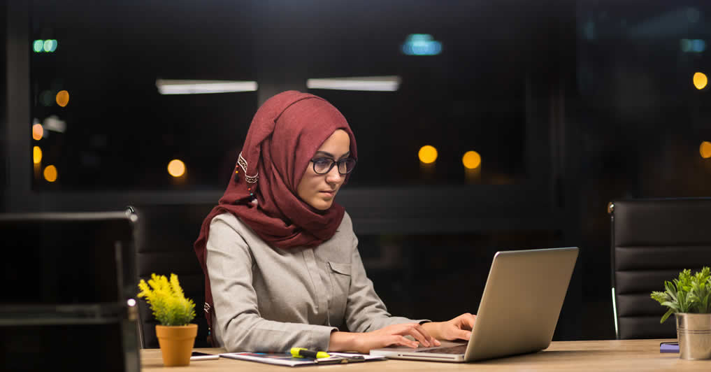 Lady at office desk working on laptop