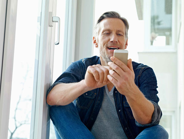 man sitting on a step looking at his phone